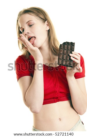 stock photo girl licking her palm while holding large bar of chocolate in