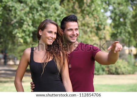 Good looking man showing something to his girlfriend