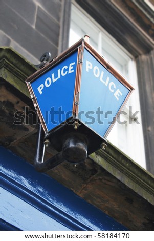 an old blue police station sign