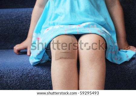 girl with plaster on her knee