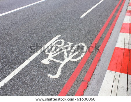 cycle lane symbol painted on a road in white and red