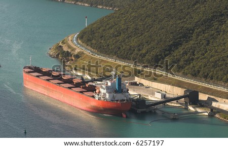 Big red ship unloading freight