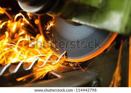Wood cutting machine  during the blade sharpening with a lot of sparks.