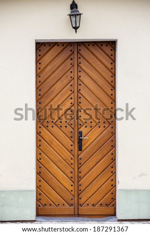 Old fashioned front door entrance to the church, all in dark brown colors, Europe