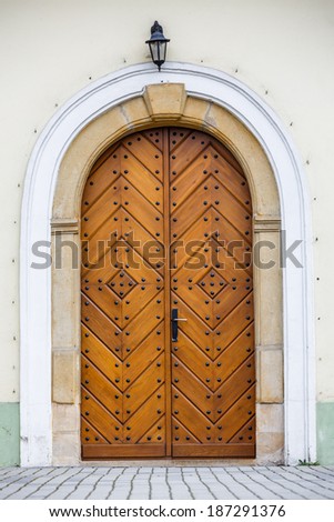 Old fashioned front door entrance to the church, all in dark brown colors, Europe