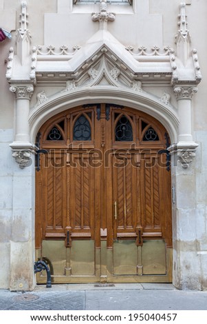 Old fashioned front door entrance, white facade and brown door, Paris