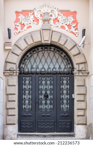 Old fashioned front door entrance, white facade and brown door, Paris