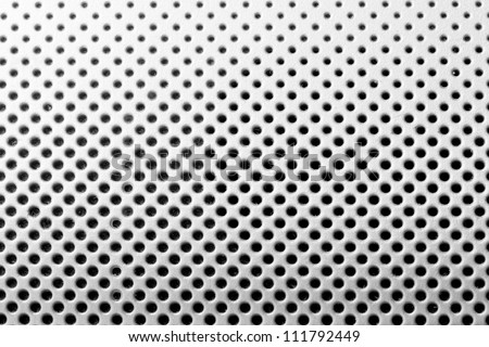 background from light metal plate with black holes