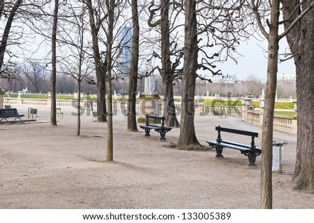 green wooden garden benches in Luxembourg Gardens in Paris