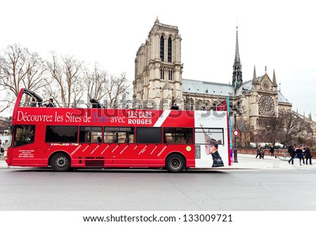 PARIS, FRANCE - MARCH 6: red sightseeing bus. The round tip lasts 2 1/4 hours and make 9 stops including Notre Dame, in Paris, France on March 6, 2013