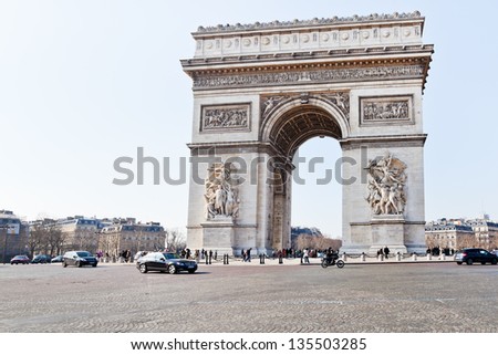 PARIS, FRANCE - MARCH 4: Triumphal Arch de l Etoile. Triumphal arch monument was designed by Jean Chalgrin in 1806, in Paris France on March 4, 2013