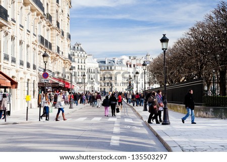 PARIS, FRANCE - MARCH 9: people on Rue du Cloitre Notre Dame. Street was formed from former cloister of Notre Dame and had the wide 14,5 m, in Paris, France on March 9, 2013
