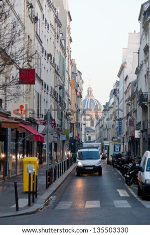 PARIS, FRANCE - MARCH 4: view of dome French Academy through Rue Mazarine. The Institut de France is a French learned society, grouping five academies, in Paris, France on March 4, 2013
