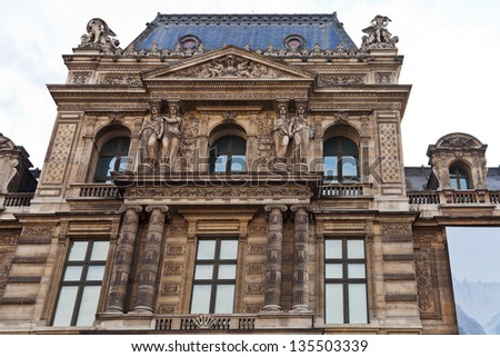 PARIS, FRANCE - MARCH 5: Louvre Museum from Place du Palais Royal. The museum is housed in the Louvre Palace which began as a fortress built in the late 12th century in Paris, France on March 5, 2013