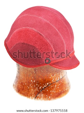 felt red cap on wooden block isolated on white background