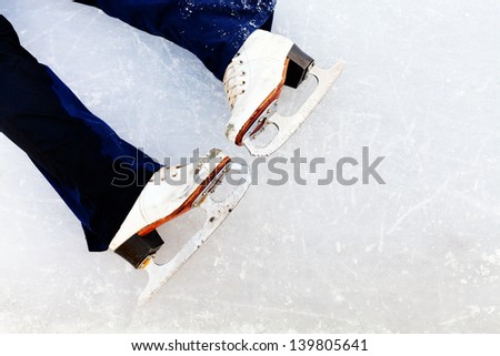 white leather skates on ice of outdoor open skating rink