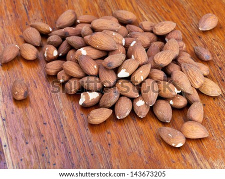 nuts of sweet almonds on wooden table