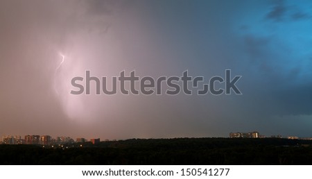 thunderstorm with lightnings over city in summer evening