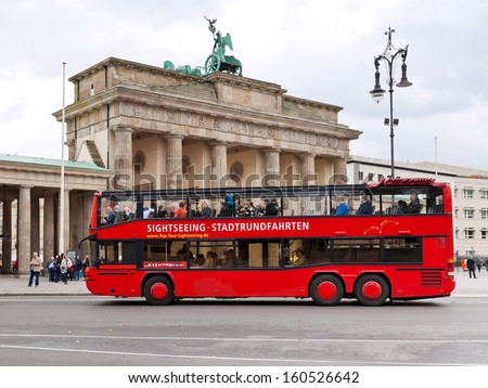 Berlin, Germany - October 17: Tourist Double Decker Bus Near Brandenburg Gate In Berlin On October 17, 2013. The Bus City Tour Takes About 2 Hours With Live Commentary Via Headã?Â?Ã?Â­Phones In 9 Languages