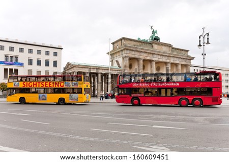 BERLIN, GERMANY - OCTOBER 17: tourist buses near Brandenburg gate in Berlin, Germany on October 17, 2013.The bus city tour takes about 2 hours with live commentary via headÃ?Â­phones in 9 languages