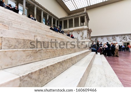 BERLIN, GERMANY - OCTOBER 16: tourists sit on steps in Hall of Pergamon museum in Berlin, Germany on October 16, 2013. Museum the most visited in Berlin it hosts more than 1.5million visitors per year