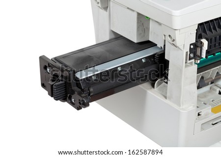 insert of toner cartridge in office multifunctional device close up