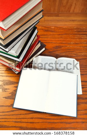 two open blank and blur font books on wooden table