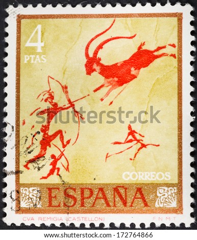 SPAIN - CIRCA 1967: A postage stamp printed in the Spain rock painting of hunting in the Remigia caves of Spain, circa 1967