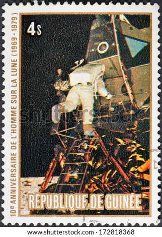 REPUBLIC OF GUINEA - CIRCA 1979: A postage stamp printed in the Republic of Guinea shows the Apollo 11 Moon Landing and first step on The Moon surface - flying on the Moon, circa 1979