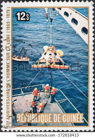 REPUBLIC OF GUINEA - CIRCA 1979: A postage stamp printed in the Republic of Guinea shows the Apollo 11 Moon Landing and first step on The Moon surface - landing on water, circa 1979