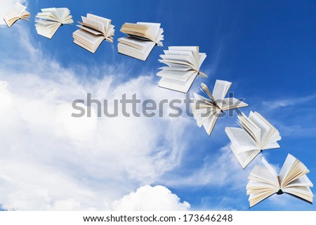 arch of flying books with blue sky and white cloud background