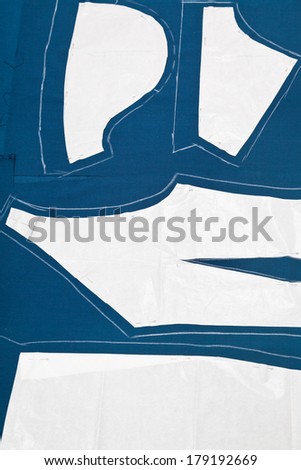 pattern and paper model of dress on blue fabric for dress cutting