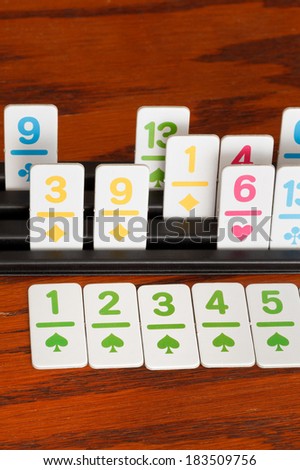 card rack - playing in rummy card game on wooden table