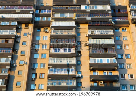 facade of urban apartment house in summer evening