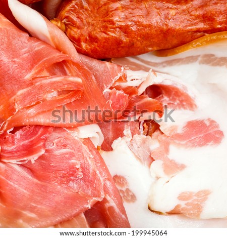 various sliced meat delicacies on plate close up