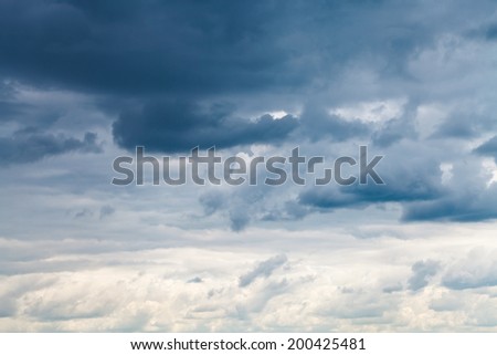 grey blue rainy clouds in overcast sky in summer