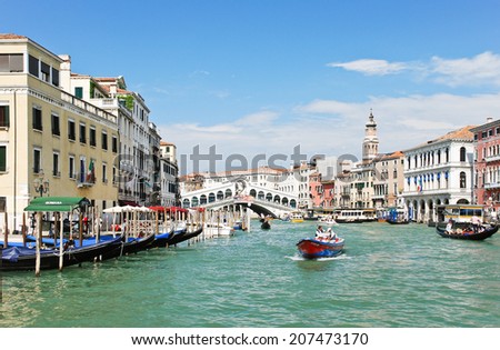 VENICE, ITALY - JULY 7, 2012: Grand Canal near Rialto Bridge (Ponte di Rialto) in Venice. The Rialto Bridge is one of the four bridges spanning the Grand Canal in Venice