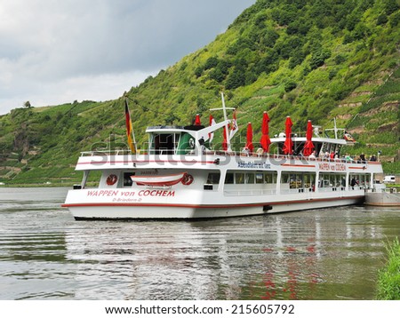 BEILSTEIN, GERMANY - AUGUST 14, 2014: excursion boat near Beilstein village, Moselle river region, Germany. Village is in Cochem-Zell district in Rhineland-Palatinate, it was was settled about AD 800.