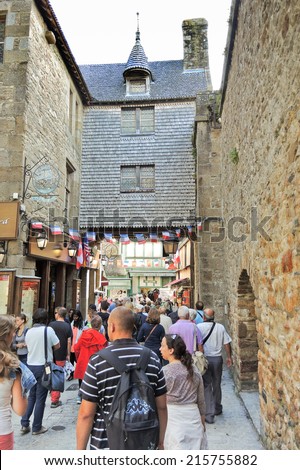 MONT SAINT-MICHEL, FRANCE - AUGUST 9, 2014: tourists in Mont Saint-Michel abbey. One of French recognisable landmarks, Mont Saint-Michel and its bay are in UNESCO list of World Heritage Sites