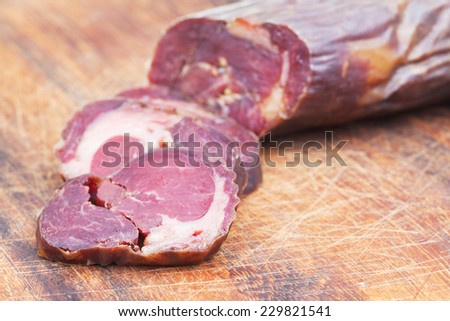 chopped horse meat sausage kazy close up on cutting wooden board