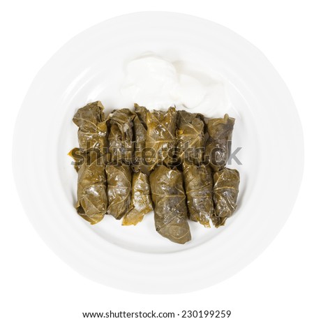 above view of portion caucasus meal - dolma from vine leaves and mince on plate isolated on white background