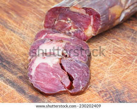 sliced horse meat sausage kazy close up on cutting wooden board