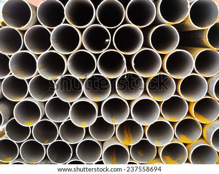rows of steel pipes close up on outdoor warehouse in winter
