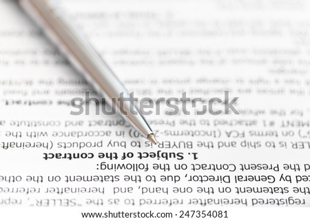 silver pen on page of sales contract close up