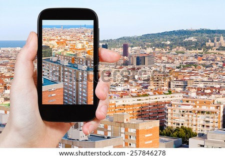 travel concept - tourist taking photo of Barcelona skyline on mobile gadget, Spain