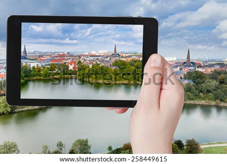 travel concept - tourist taking photo of Copenhagen center on mobile gadget, Denmark