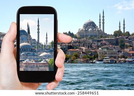 travel concept - tourist taking photo of Istanbul skyline on mobile gadget, Turkey