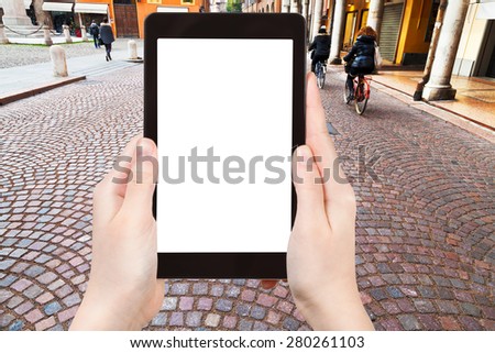 travel concept - tourist photograph via Emilia - ancient street in Modena, Italy on tablet pc with cut out screen with blank place for advertising logo