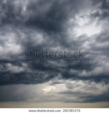 heavy low storm clouds in evening spring sky