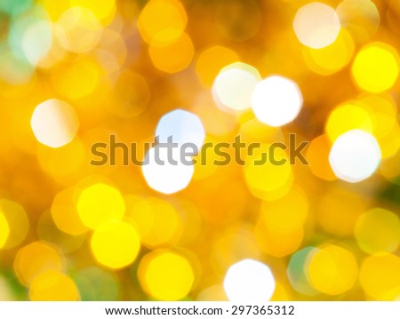 abstract blurred background - bright yellow and green shimmering Christmas lights of electric garlands on Xmas tree